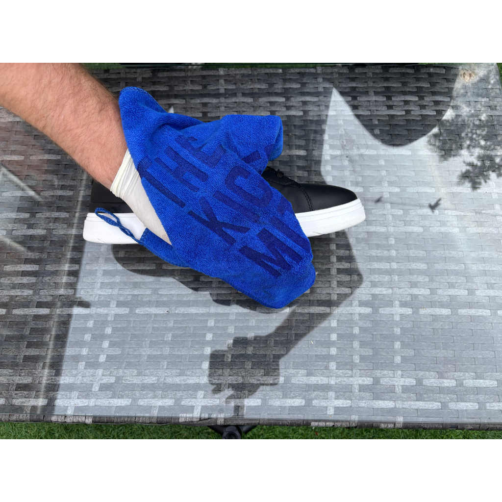 The Kicker Mitt Complete Shoe Cleaning Kit including blue mitt, branded microfibre towel, and lemon Shoe Goo cleaner in packaging