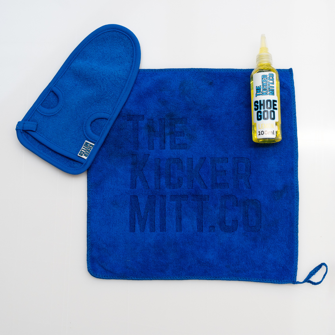 Blue towel with 'The Kicker Mitt Co' branding, a blue mitt, and a bottle of 'Shoe Goo' on a white background.